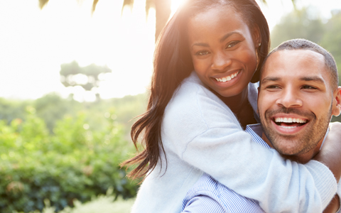 Smiling couple from Waldorf showing off their brand new porcelain dental veneers.