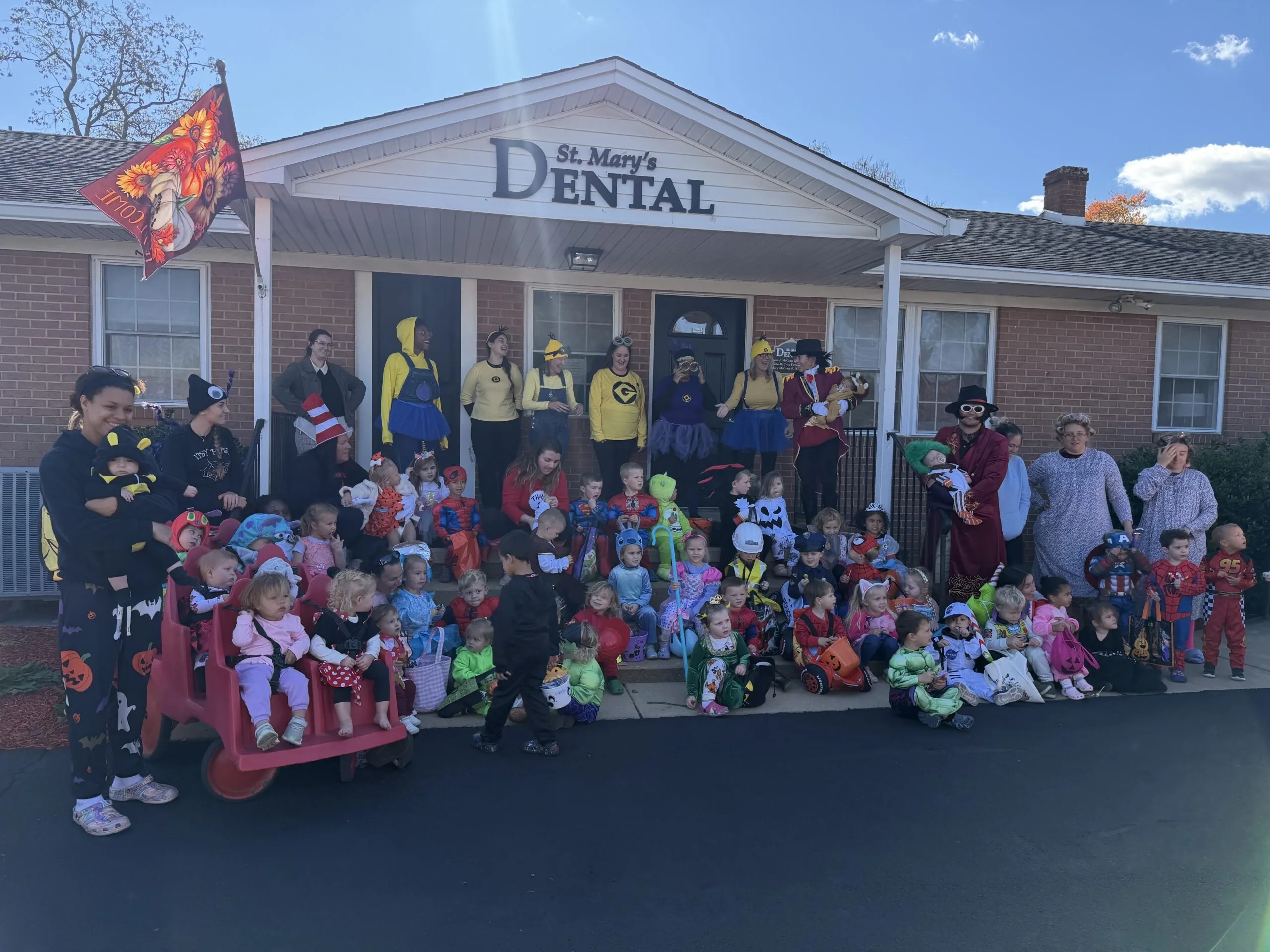St. Mary’s Dental team celebrating Halloween with children and families outside the dental office.